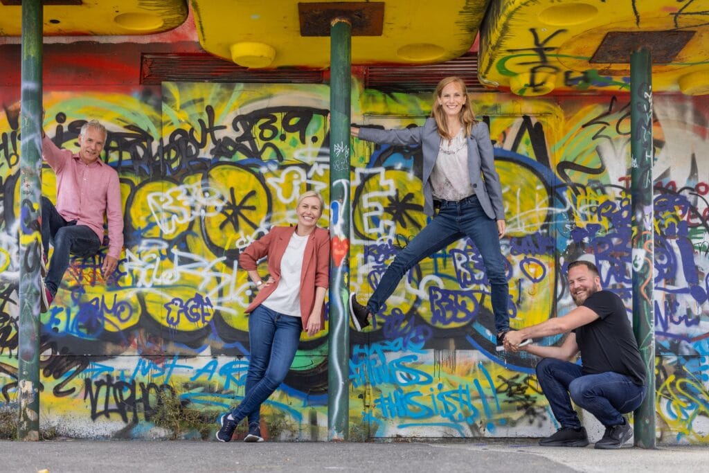 A photo of the BikeFinder leader group in front of a graffiti wall