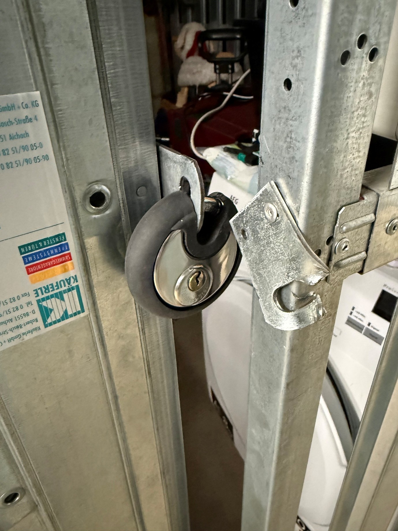 Broken lock of basement where bike was stolen, tracked with BikeFinder and recovered